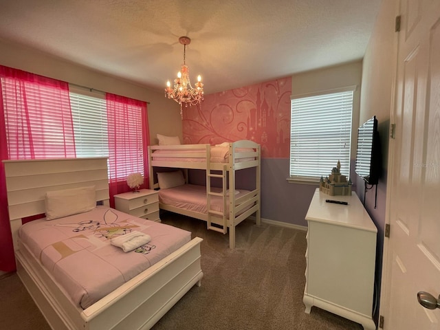 bedroom featuring a textured ceiling, dark carpet, and a notable chandelier