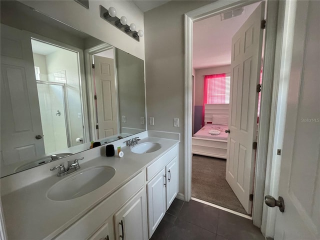 bathroom featuring vanity, tile patterned floors, and a shower with door