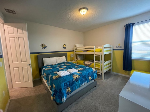 carpeted bedroom featuring a textured ceiling