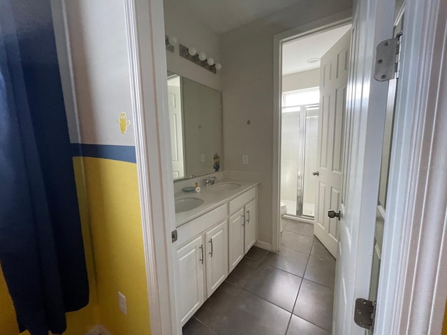 bathroom with vanity, tile patterned flooring, and toilet