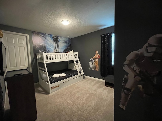 bedroom with a textured ceiling and carpet floors