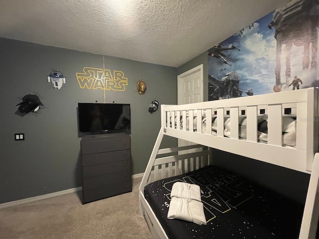 bedroom with a textured ceiling and carpet flooring