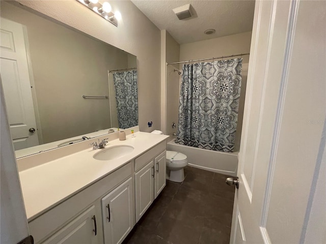 full bathroom with shower / bath combination with curtain, vanity, a textured ceiling, tile patterned flooring, and toilet