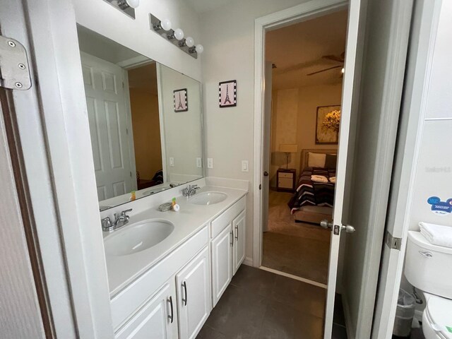 bathroom featuring tile patterned floors, vanity, ceiling fan, and toilet