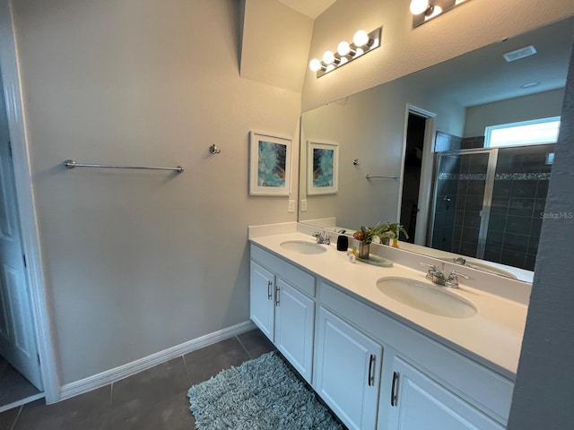 bathroom featuring vanity, a shower with shower door, and tile patterned flooring