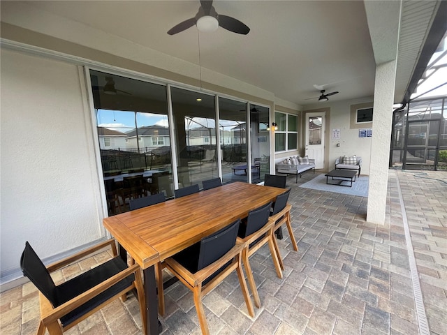 view of patio / terrace with an outdoor living space, a lanai, and ceiling fan