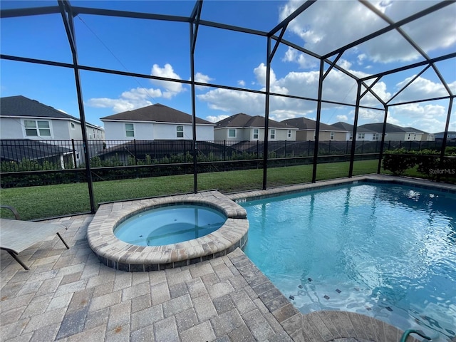 view of pool with a patio area, a lawn, glass enclosure, and an in ground hot tub