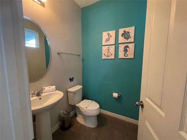 bathroom featuring tile patterned flooring, sink, and toilet