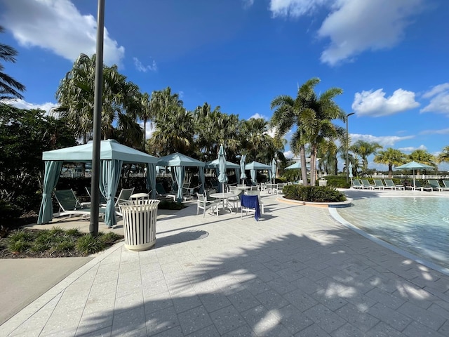 surrounding community featuring a patio, a pool, and a gazebo