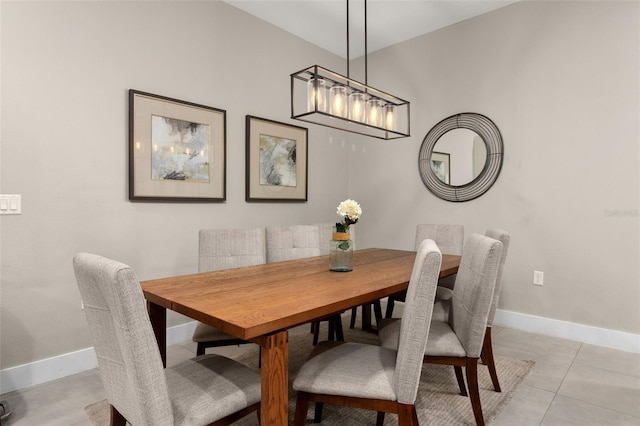 dining room featuring light tile patterned flooring and lofted ceiling