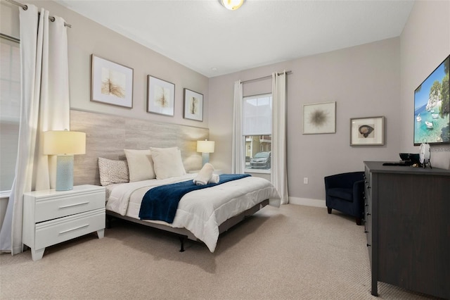 bedroom featuring light carpet