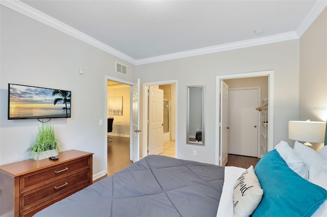 1301 Tuscan Ter Unit 9106, Davenport, FL 33896 - bedroom with crown molding, wood finished floors, baseboards, and ensuite bath