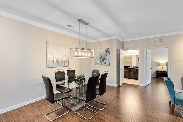 dining area with crown molding and light hardwood / wood-style flooring