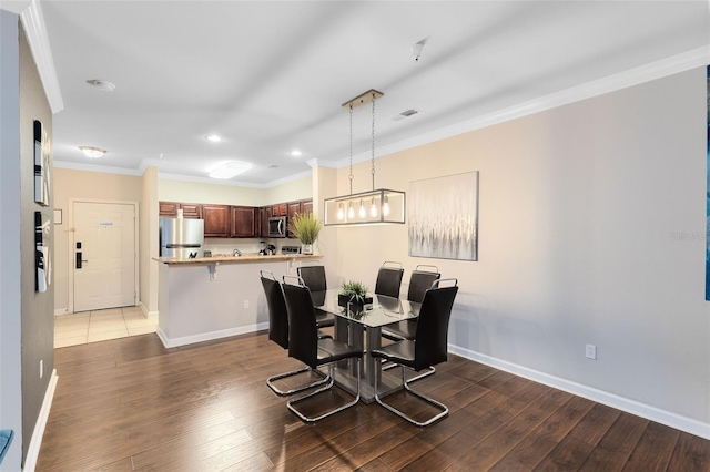 dining area featuring crown molding and dark hardwood / wood-style floors