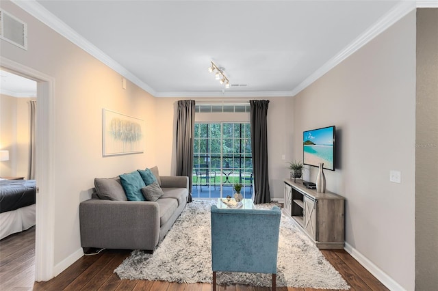 living room with dark hardwood / wood-style floors, ornamental molding, and track lighting