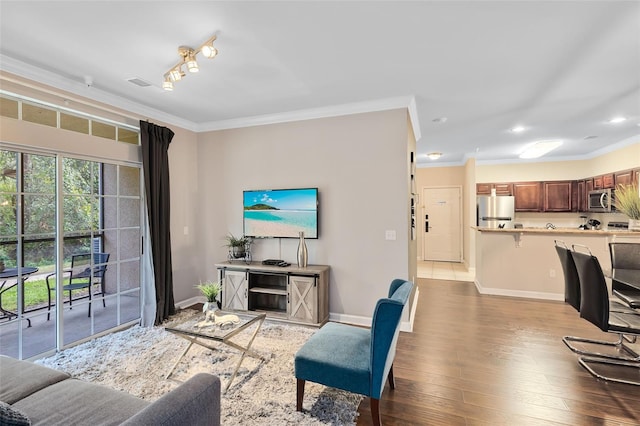 living room with hardwood / wood-style flooring and ornamental molding