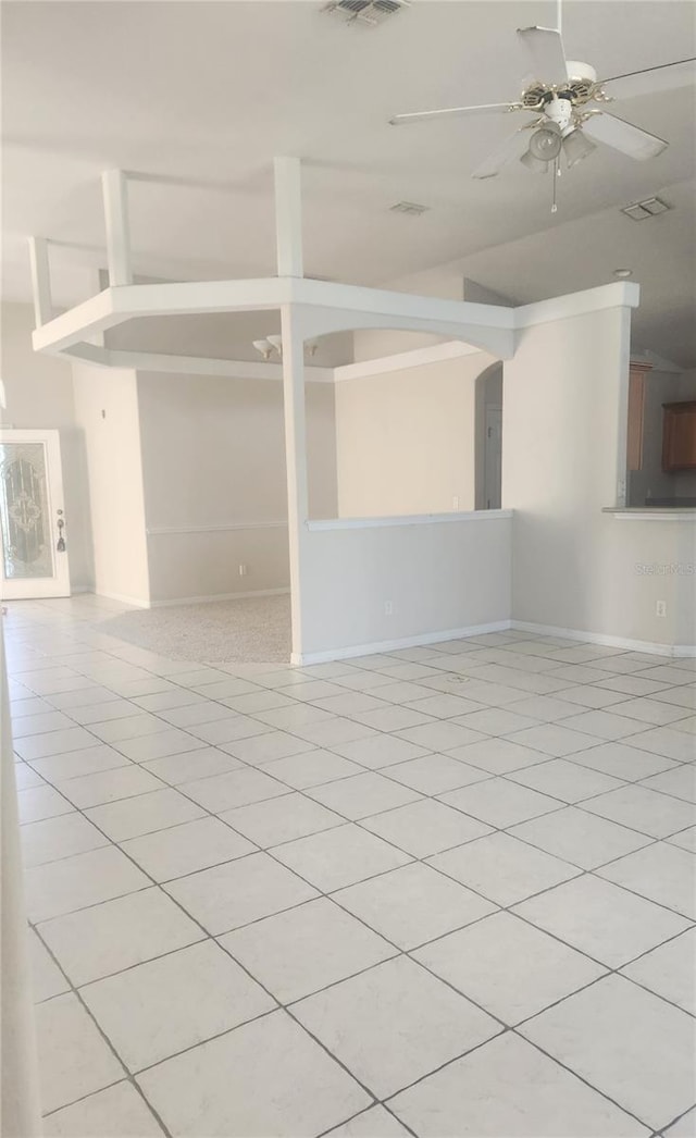 empty room with ceiling fan and light tile patterned flooring