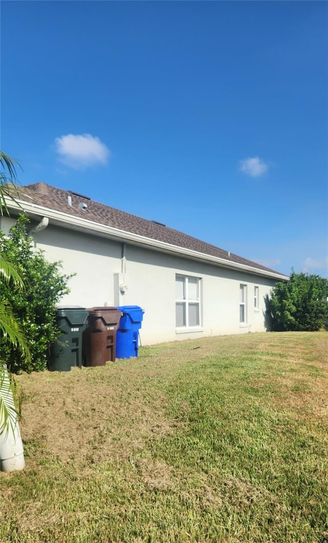 rear view of property featuring a lawn