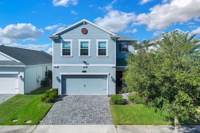 front facade featuring a front yard and a garage