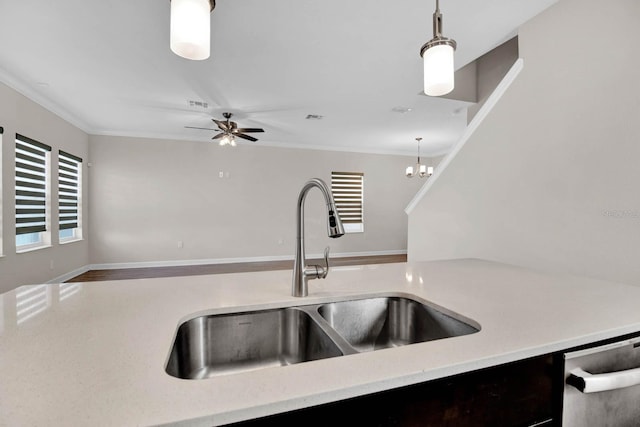 kitchen featuring ornamental molding, ceiling fan with notable chandelier, sink, pendant lighting, and dishwasher