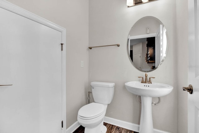 bathroom with sink, toilet, and hardwood / wood-style flooring