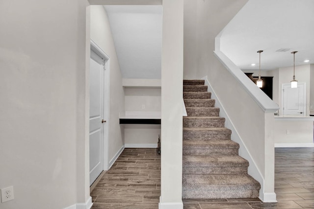 stairs with hardwood / wood-style flooring