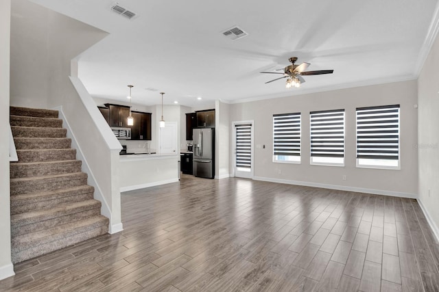 unfurnished living room with dark hardwood / wood-style flooring, ceiling fan, crown molding, and sink