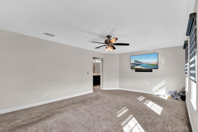 unfurnished living room featuring carpet flooring and ceiling fan