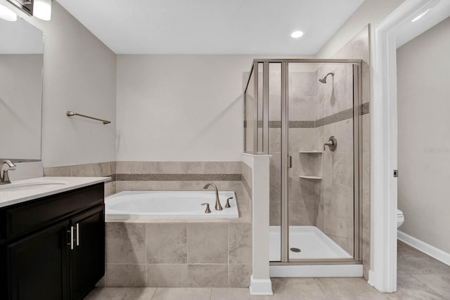 full bathroom with tile patterned floors, separate shower and tub, vanity, and toilet