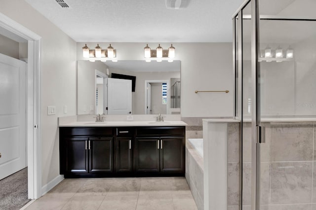 bathroom featuring vanity, shower with separate bathtub, a textured ceiling, and tile patterned floors