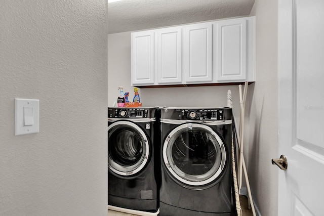 laundry area featuring cabinets and washer and dryer