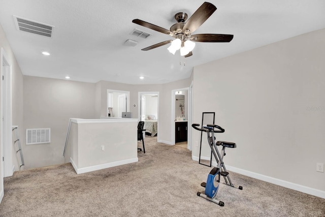 exercise room featuring light carpet and ceiling fan