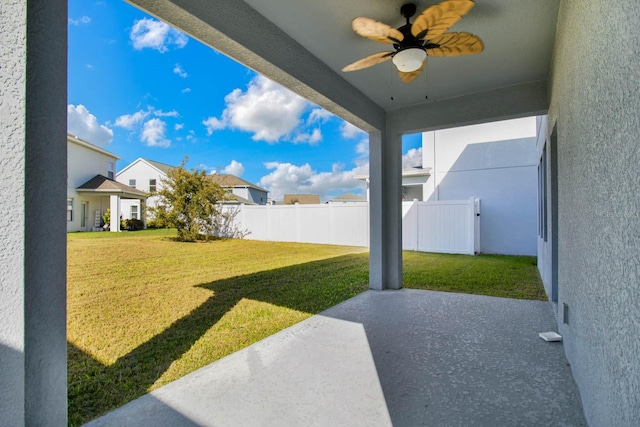 view of yard featuring ceiling fan and a patio area