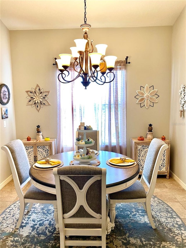 tiled dining room with a notable chandelier