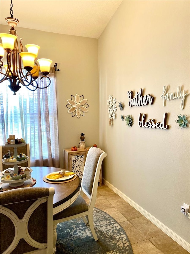 dining area with a notable chandelier and light tile patterned flooring