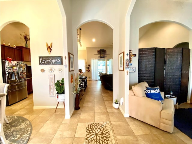 hall featuring light tile patterned floors