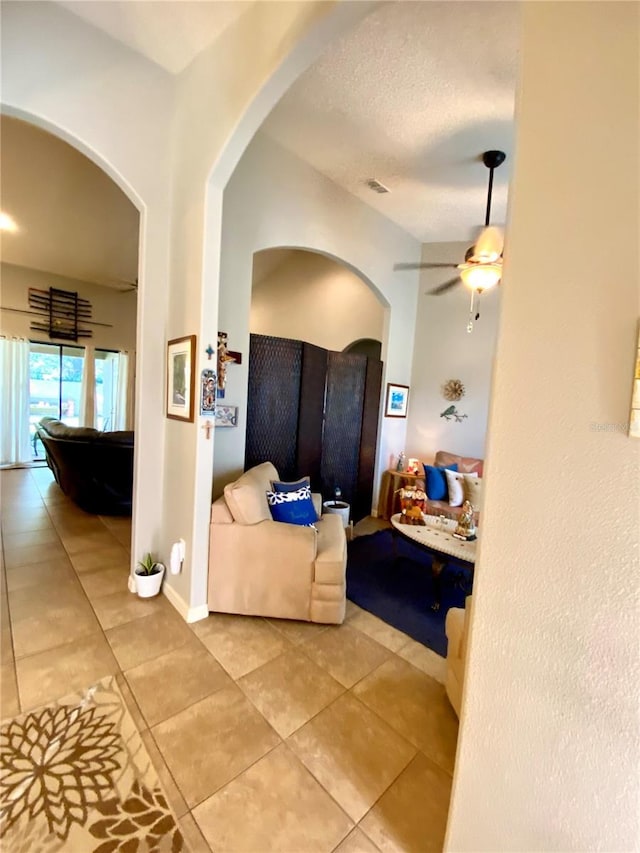 tiled bedroom with ceiling fan