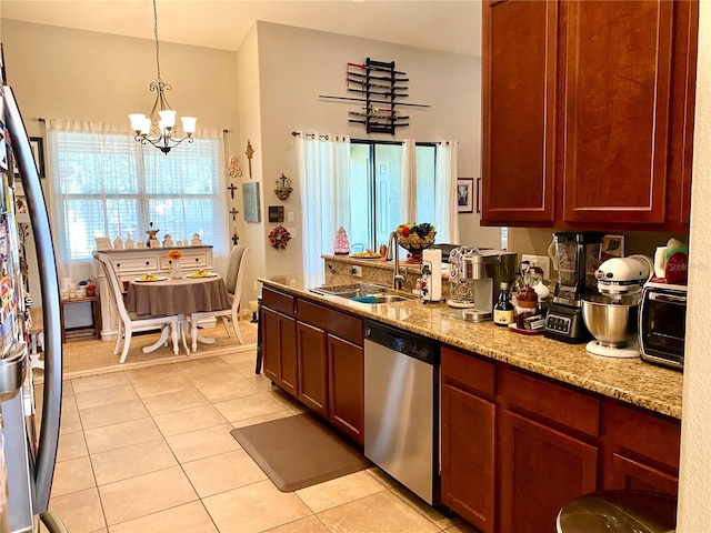 kitchen featuring sink, stainless steel dishwasher, light stone countertops, light tile patterned flooring, and a chandelier