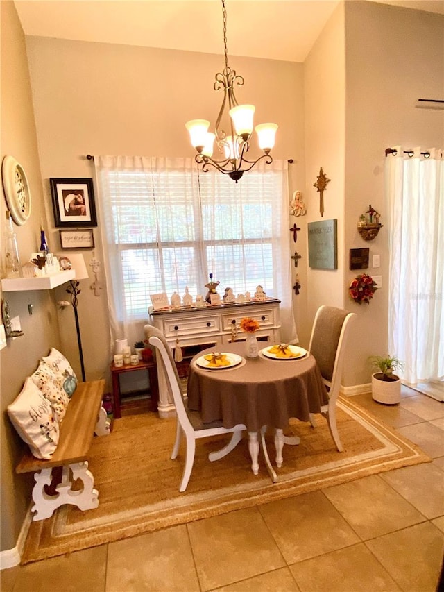 dining room featuring tile patterned flooring and an inviting chandelier