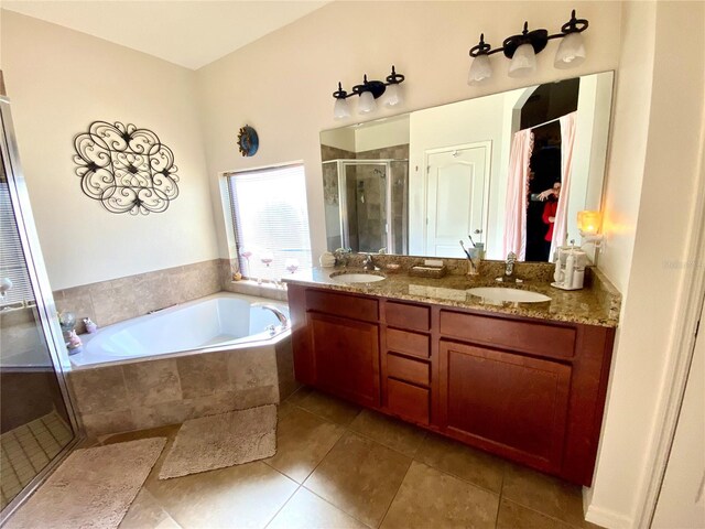 bathroom featuring plus walk in shower, vanity, and tile patterned floors