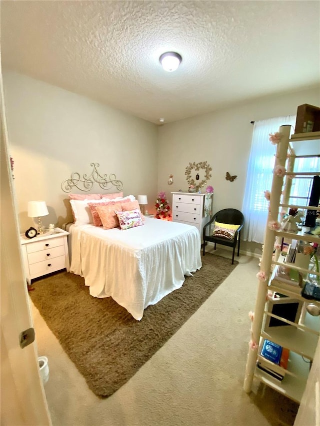 carpeted bedroom with a textured ceiling