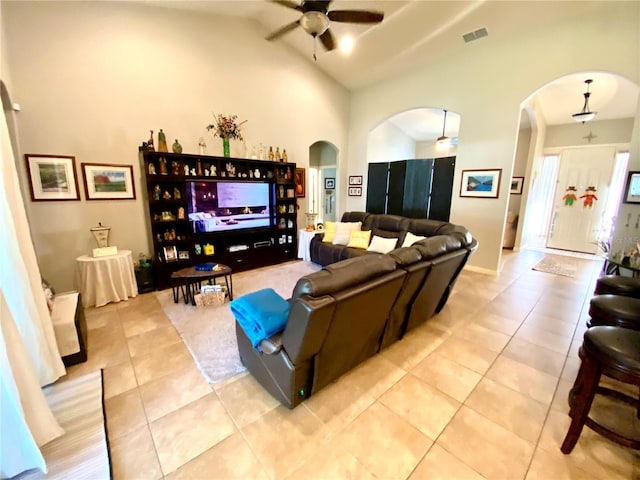 living room featuring light tile patterned floors, vaulted ceiling, and ceiling fan