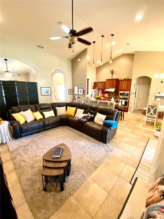 living room with light tile patterned floors, high vaulted ceiling, and ceiling fan