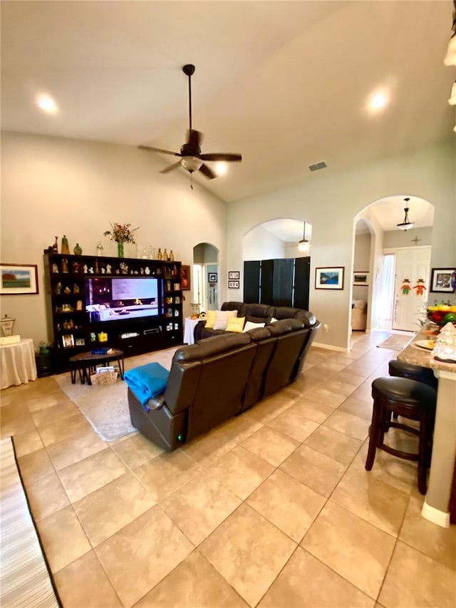 tiled living room featuring vaulted ceiling and ceiling fan