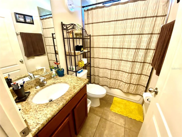 full bathroom featuring tile patterned flooring, shower / bath combo, vanity, and toilet