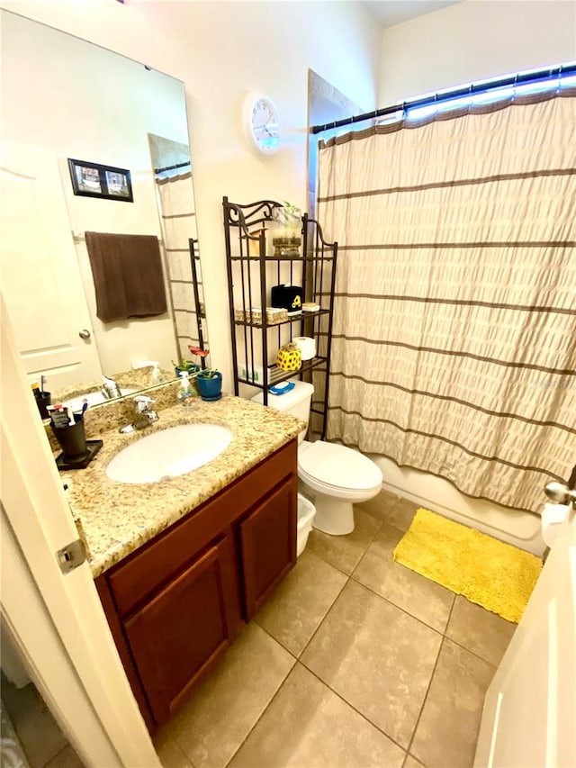 full bathroom featuring tile patterned floors, vanity, toilet, and shower / bath combo with shower curtain