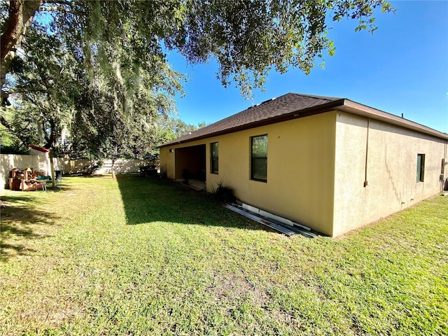 view of side of property with a yard