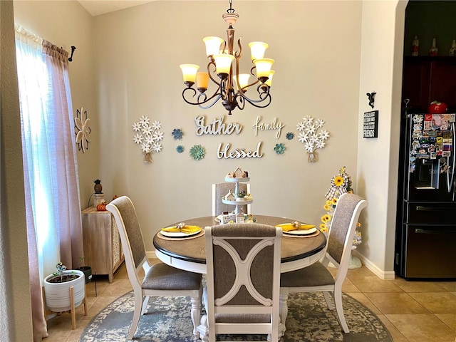 tiled dining area with a chandelier