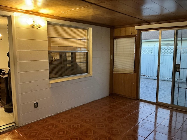 unfurnished room with wood walls and wooden ceiling