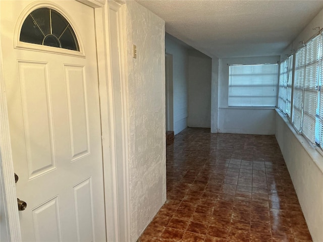 corridor with a textured ceiling